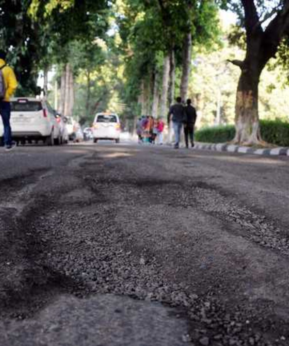 Jammu roads: Filling potholes with sand and dust